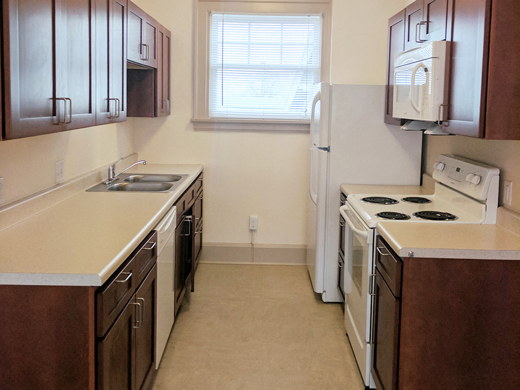 a kitchen with a stove refrigerator and a sink