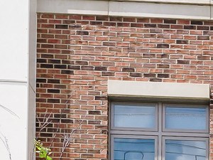 3415 Reading a brick building with a clock on the side of it