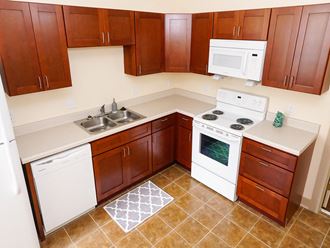 a kitchen with white appliances and wooden cabinets