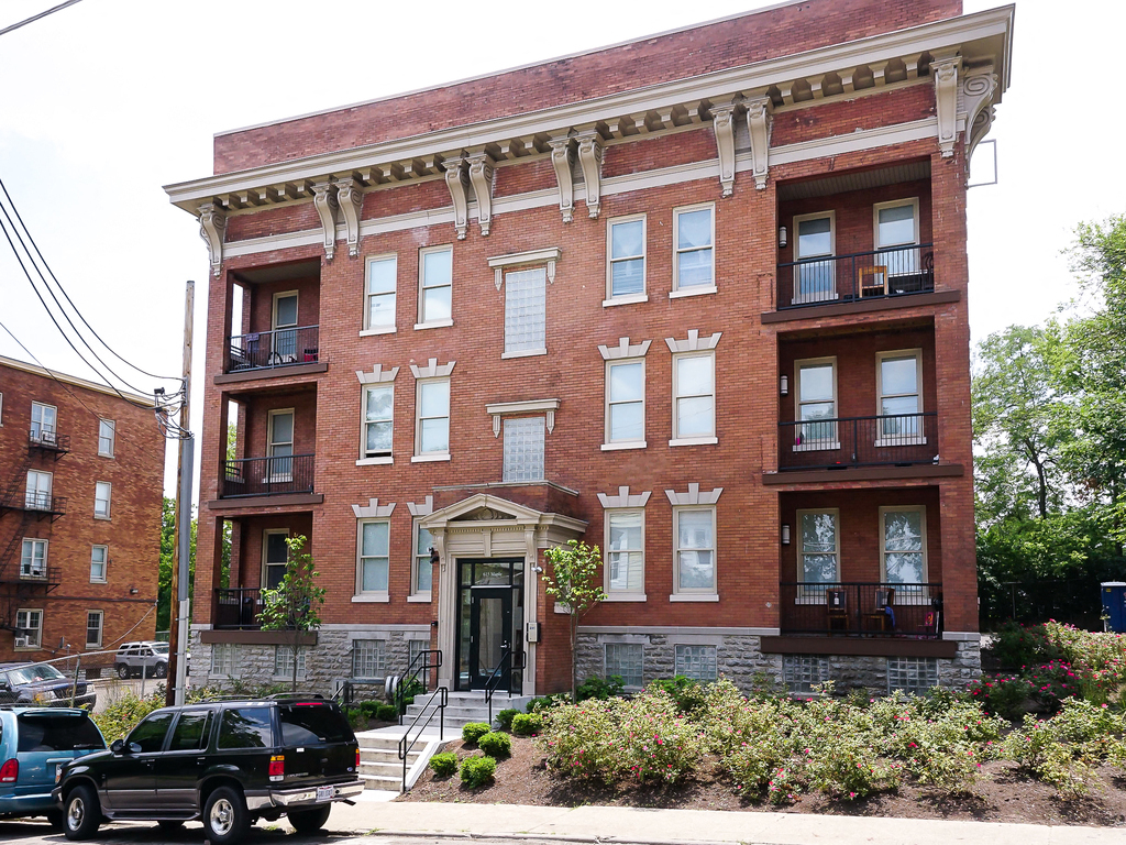 a large brick building with cars parked in front of it