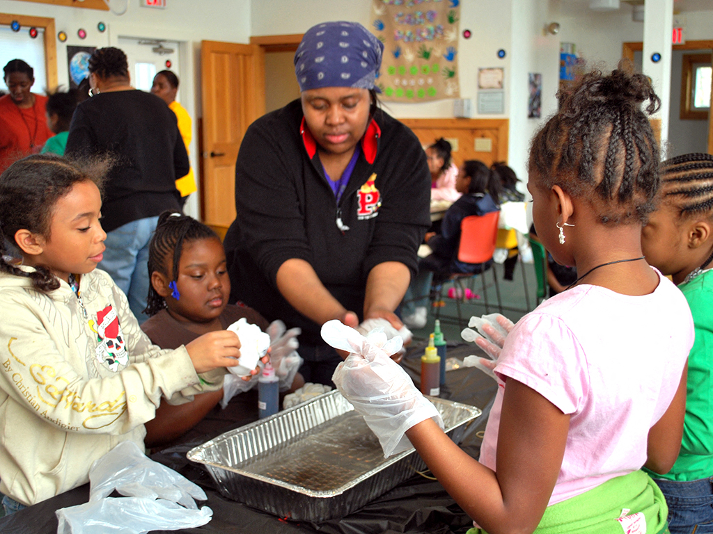 a group of young children doing a science experiment in a classroom