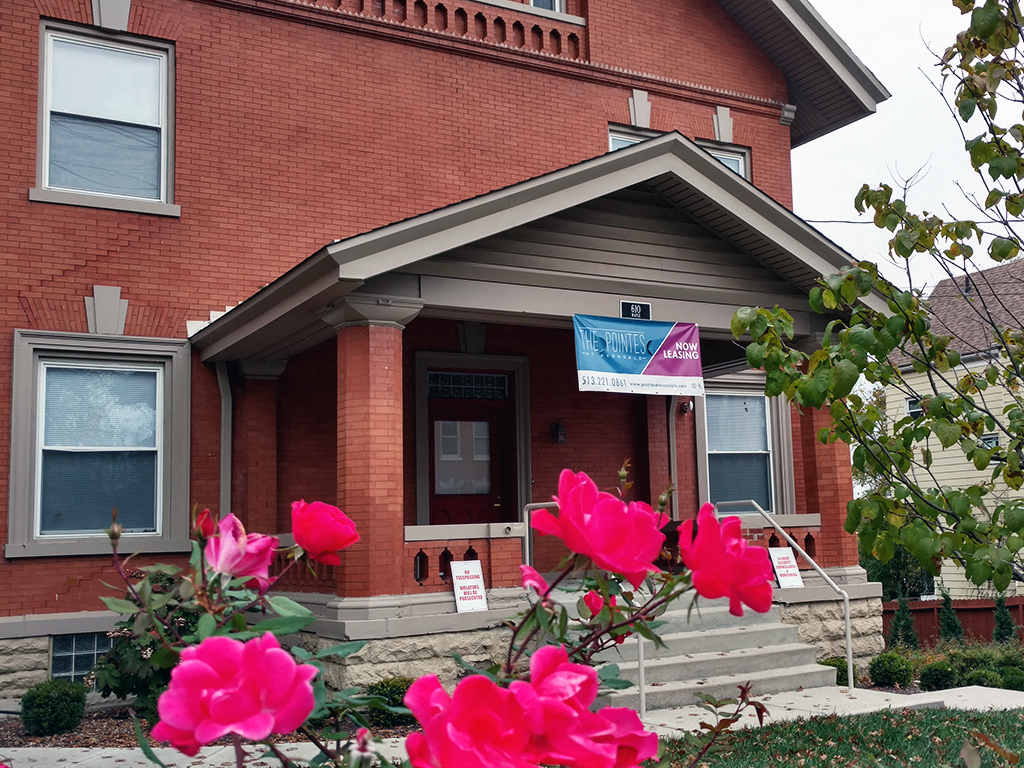 a building with pink flowers in front of it