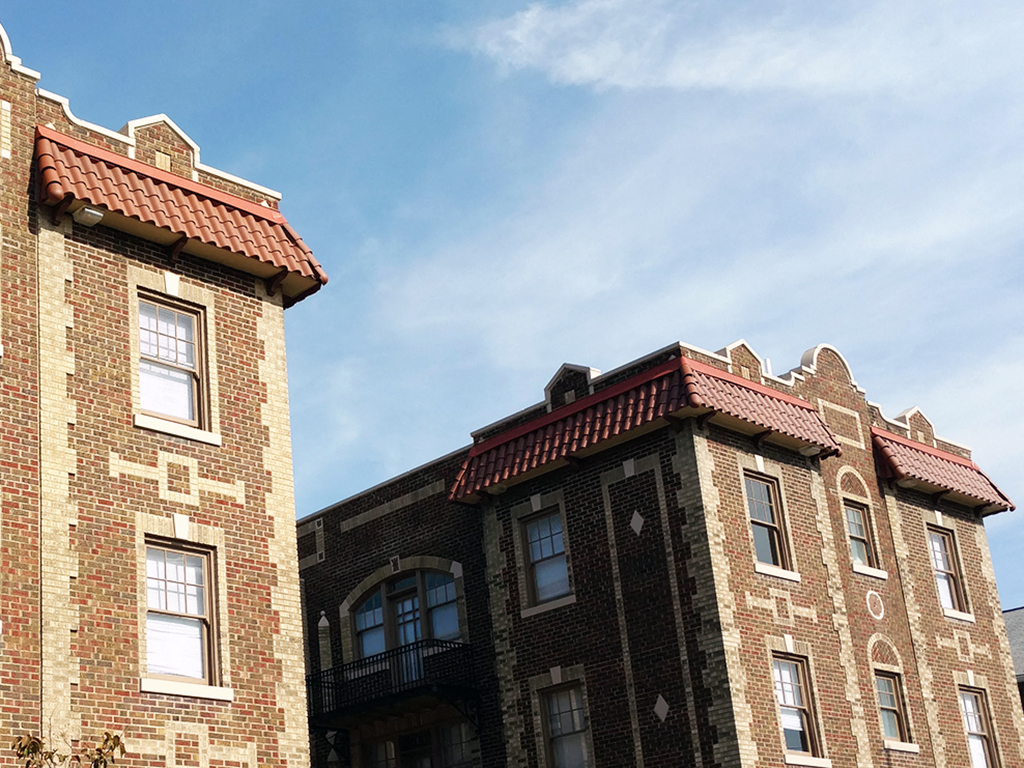 a brick building with a blue sky in the background
