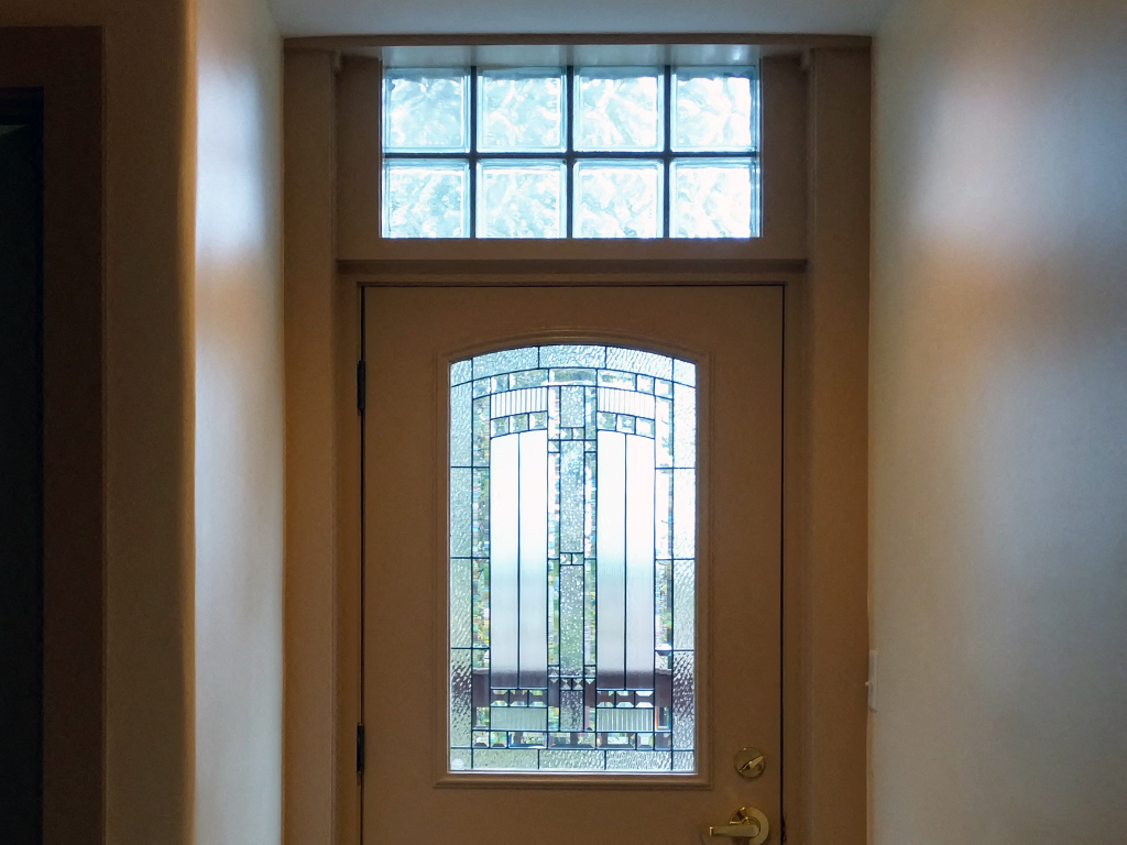 a door with a glass window and a door handle