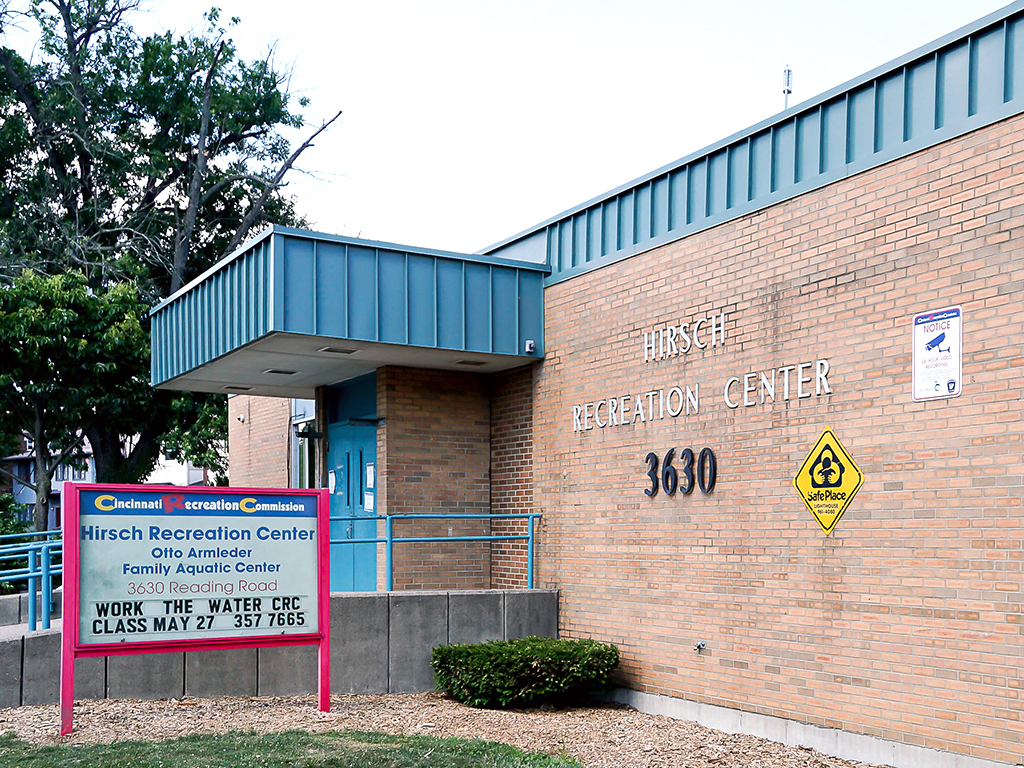 a brick building with a sign outside of the hhs dedication center