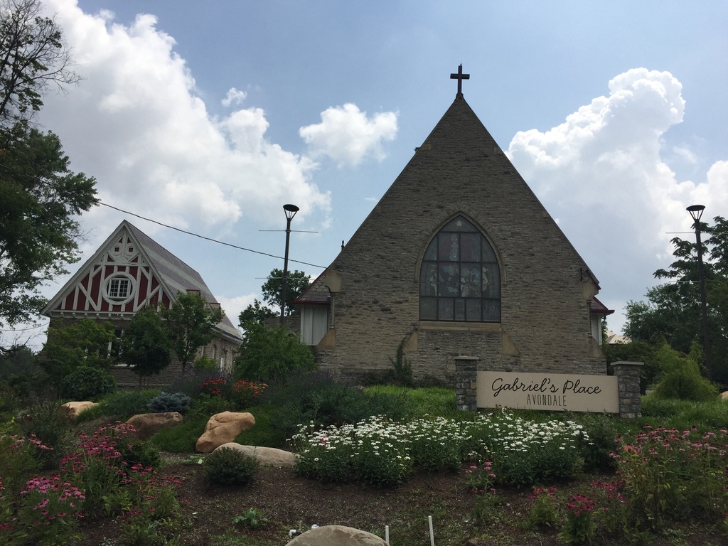 a church with a garden in front of it