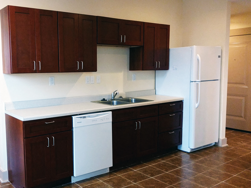 a kitchen with a sink and a refrigerator