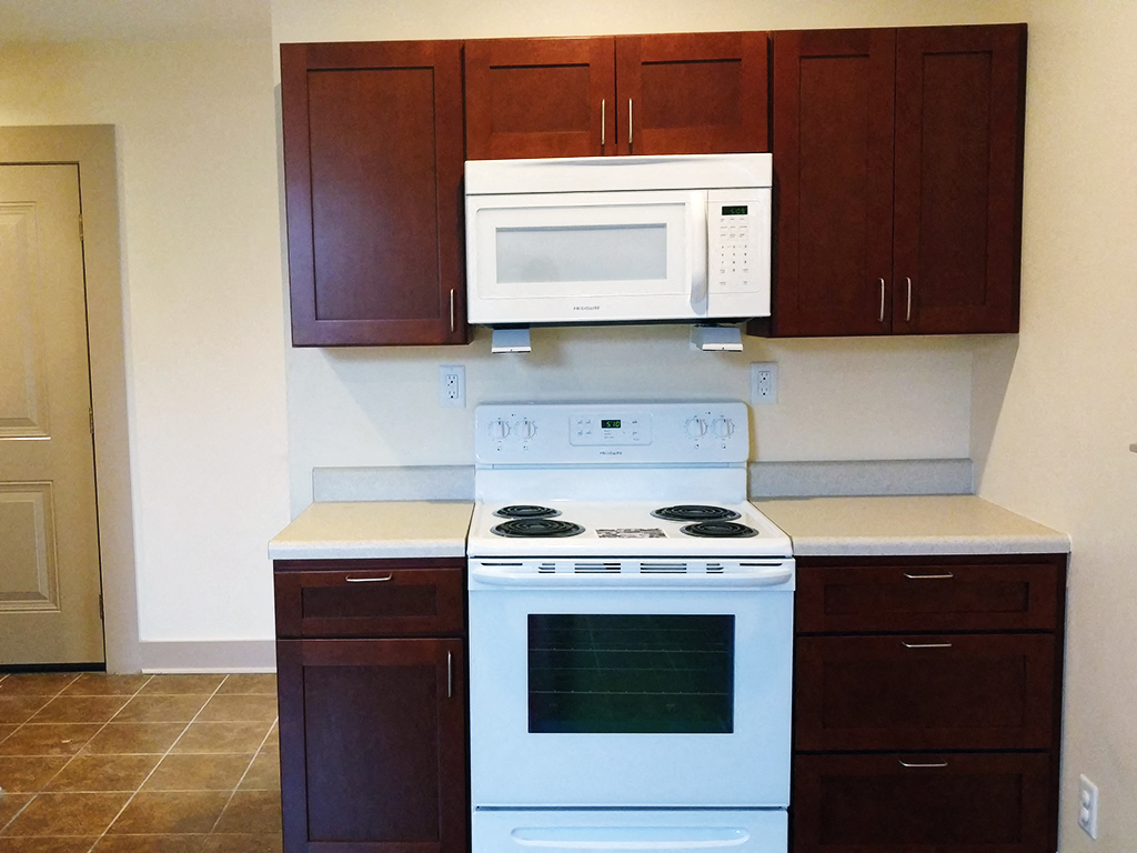 a kitchen with a stove microwave and cabinets