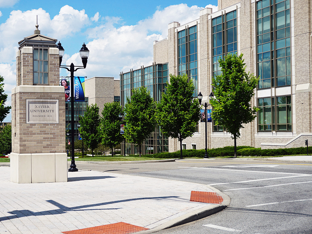 an empty street in front of a building with a clock tower