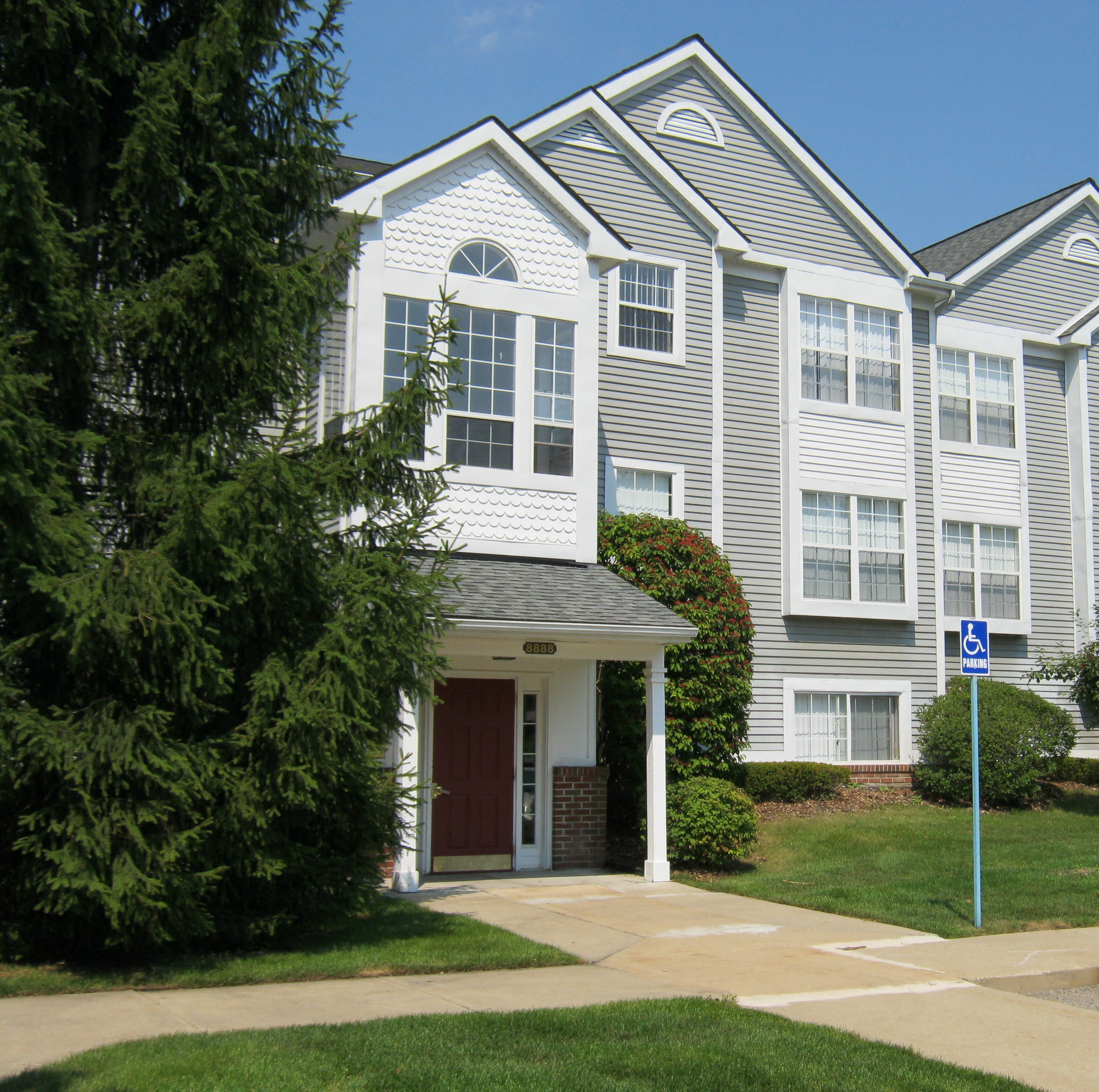 a white house with a sidewalk in front of it