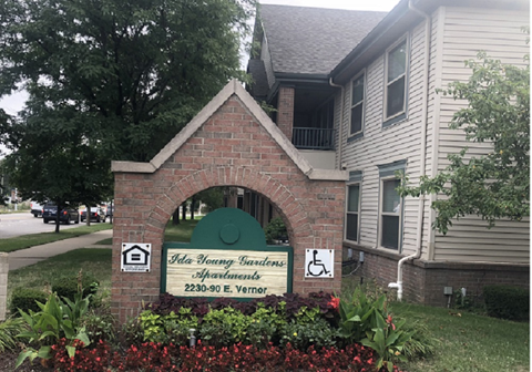a brick monument sign in front of a house