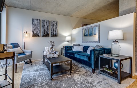 a living room with a blue couch and a coffee table