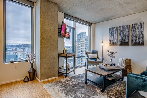 a living room with a large window and a view of the city