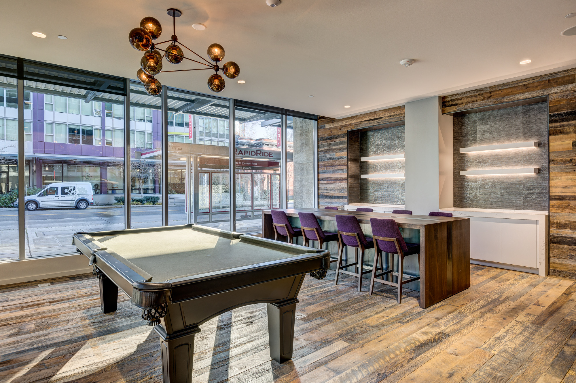 a game room with a pool table and a bar