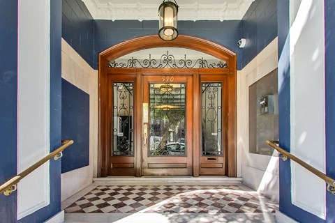 A wooden door with glass panels and a sign above it that reads "990".