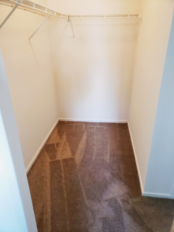 a empty room with a wooden floor and white walls