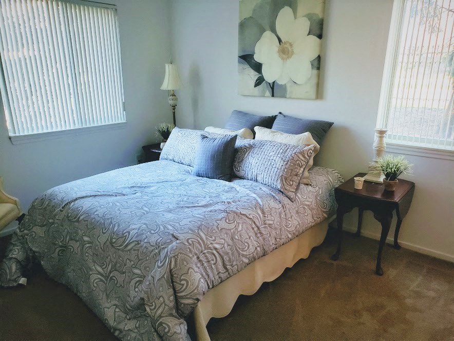 a bedroom with a bed and a side table