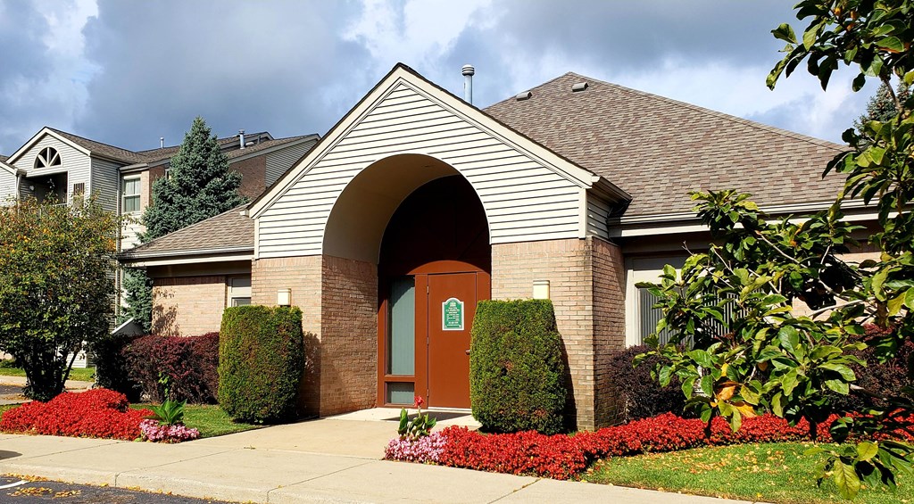 a house with an arched doorway and a sidewalk