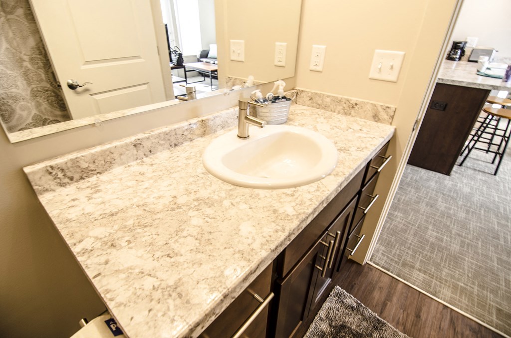 an image of a bathroom with a sink and a mirror