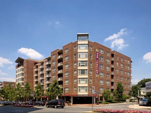 a large brick building with cars parked in front of it