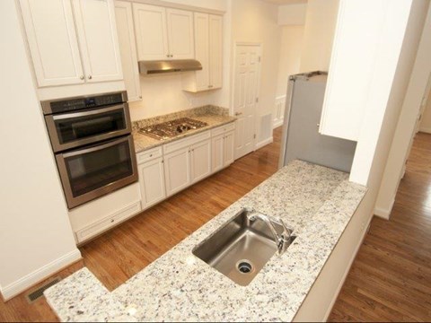 a kitchen with white cabinets and a sink