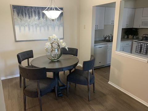 a kitchen and dining area with a table and chairs