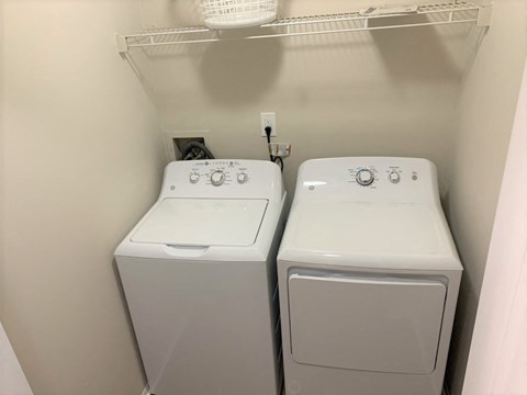 a laundry room with two washes and a dryer