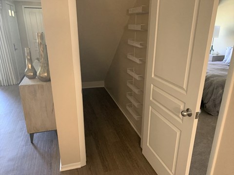 a room with a closet and a bed and a white door