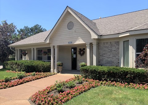 the front of a house with a walkway and landscaping