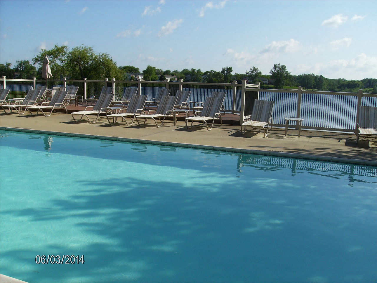 A pool with chairs around it and a date stamp of 06/03/2014.