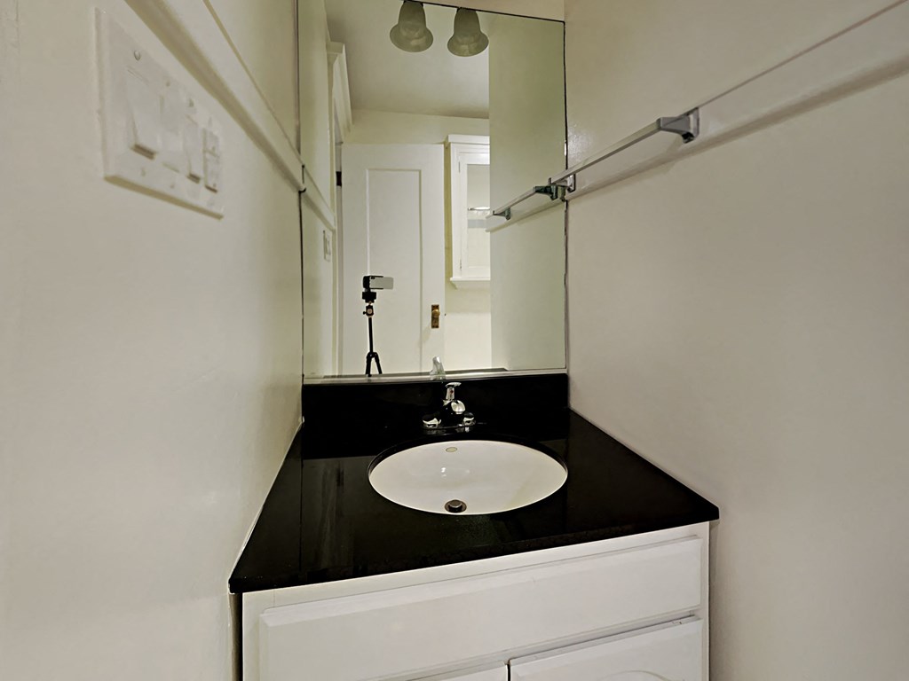 a small bathroom with a sink and a mirror