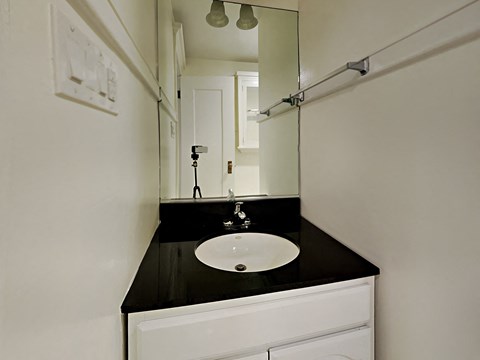 a small bathroom with a sink and a mirror