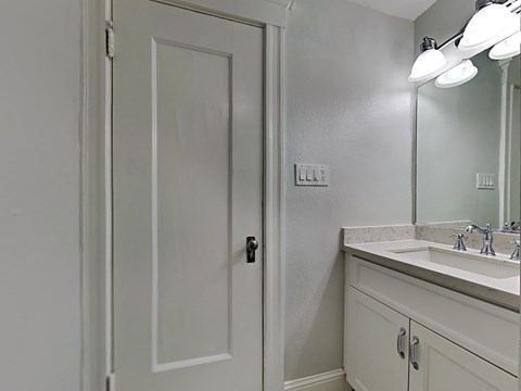 an empty bathroom with a sink and a shower