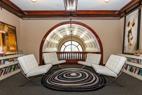 a group of white chairs in a room with a large window