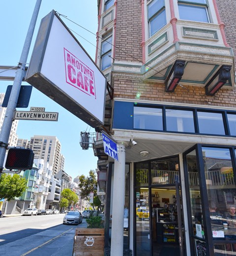 the outside of a cafe on the corner of a city street