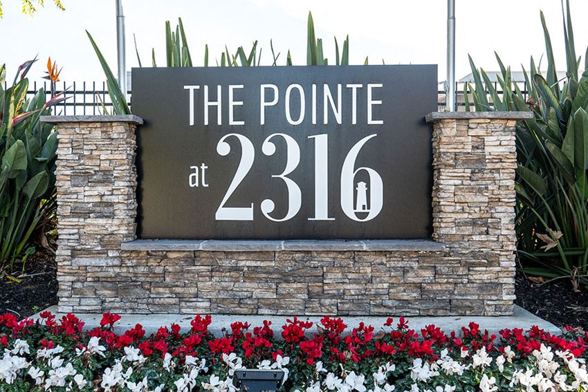 Community Monument Sign with flowers l The Pointe at 2316 - Photo Gallery 1