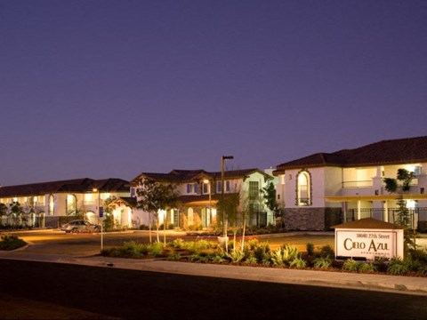 a group of houses on a street at night