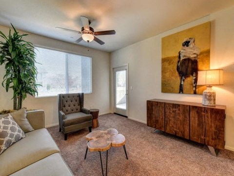 a living room with a couch and a ceiling fan