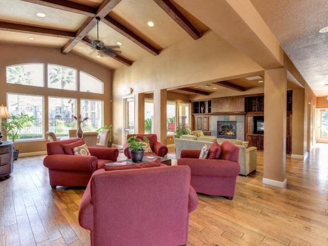a large living room with furniture and a ceiling fan