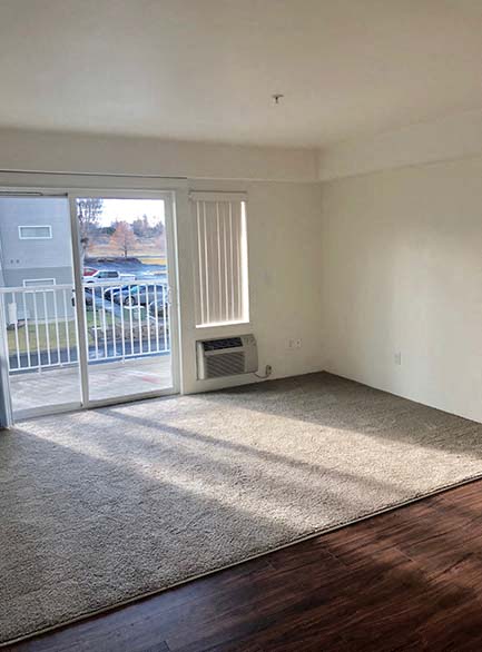 Heron Creek Apartments l Living room with balcony