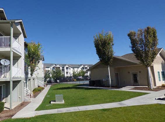 Heron Creek Apartments l Exterior buildings with grass