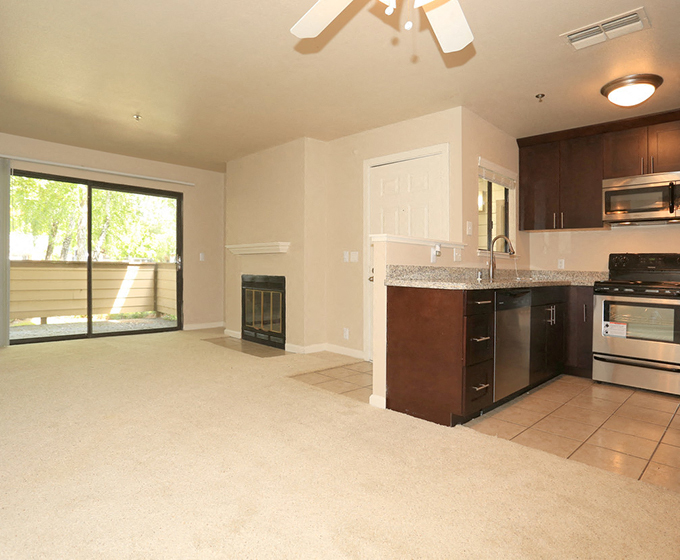 Living room with fireplace neat kitchen Hidden Creek Apts rentals in Vacaville Ca 95687