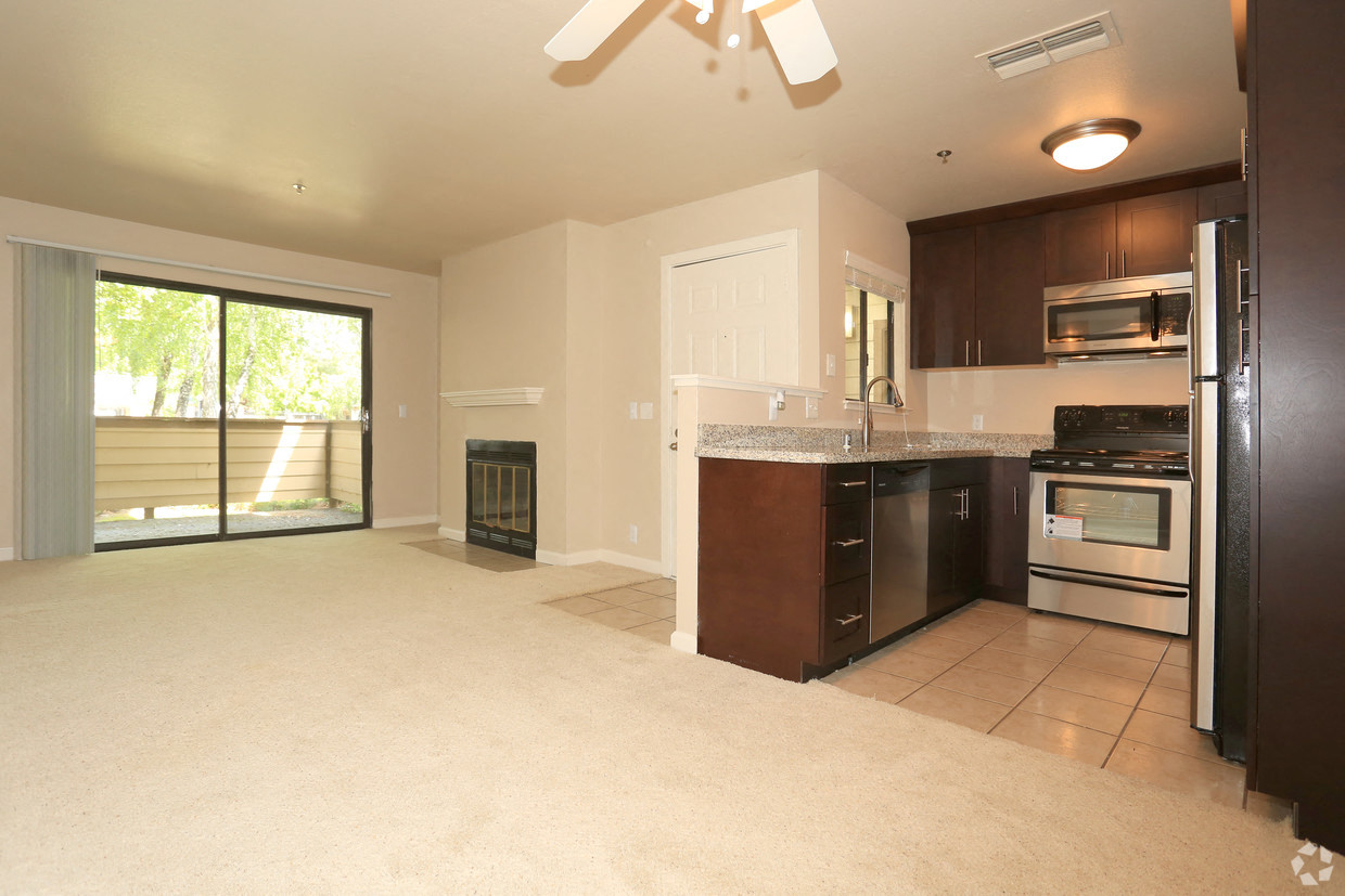 Living room with fireplace and kitchen Hidden Creek Apts rentals in Vacaville Ca 95687