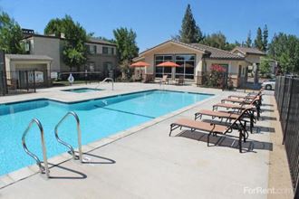 Pet-Friendly Apartments in Sacramento CA - La Provence - Large Pool, Gated Area, Lounge Chairs, and Manicured Lawn