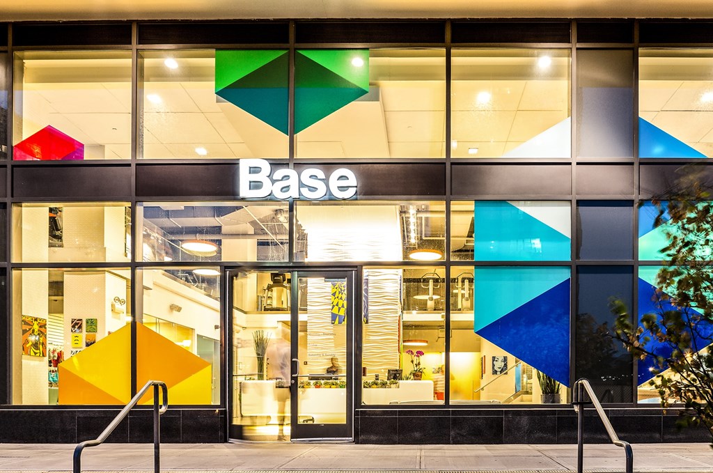 a large glass building with the base logo on it