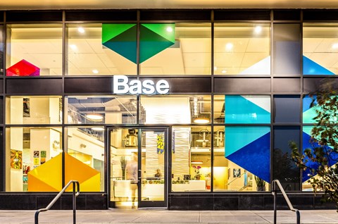 a large glass building with the base logo on it