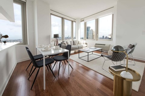 a living room with a table and chairs and a couch