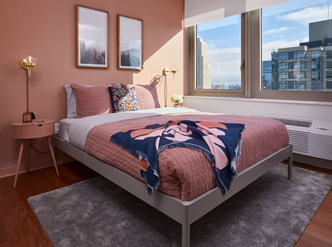 a bedroom with a bed and three windows