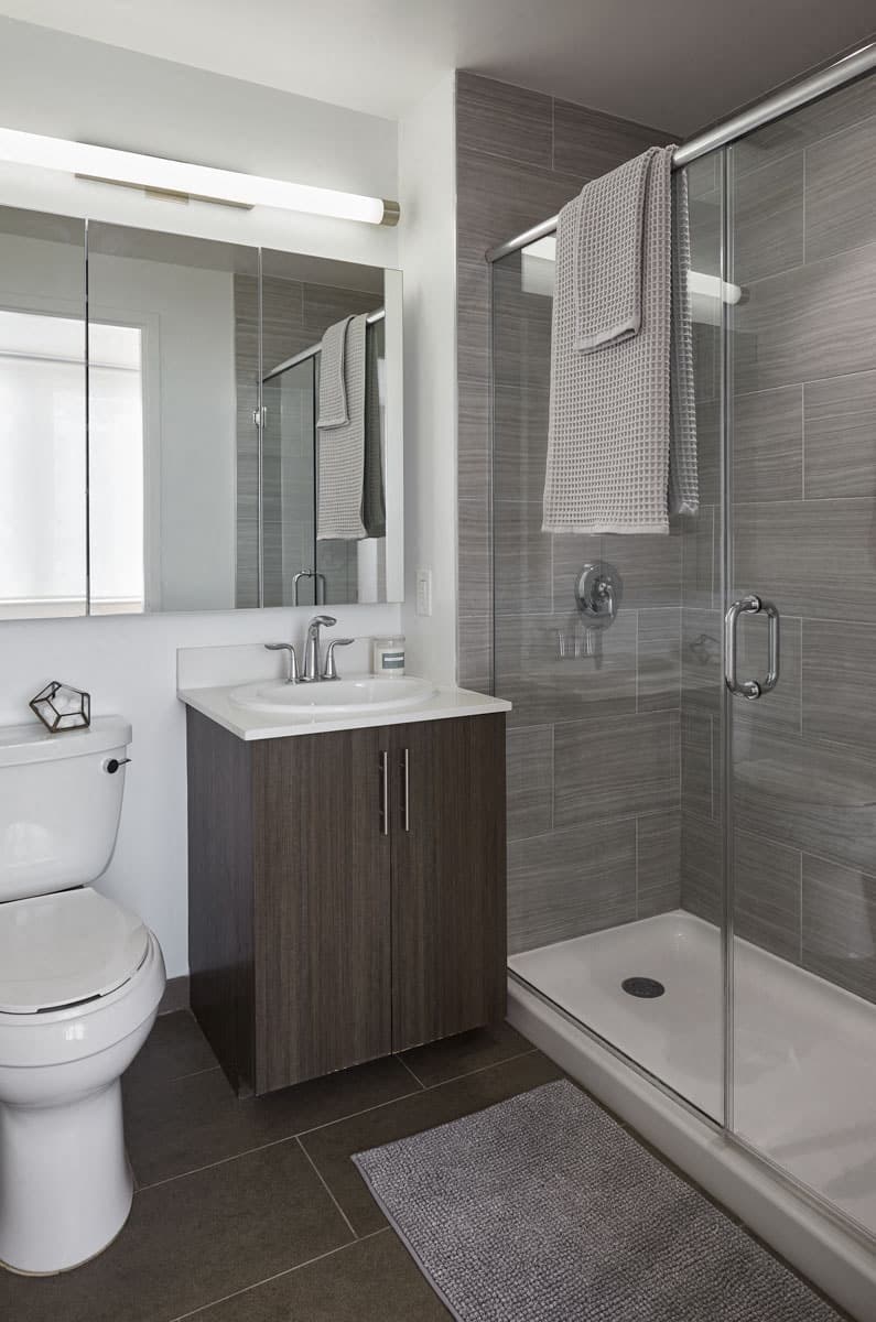 a bathroom with a toilet sink and shower