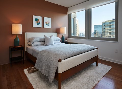 a bedroom with a bed and two windows